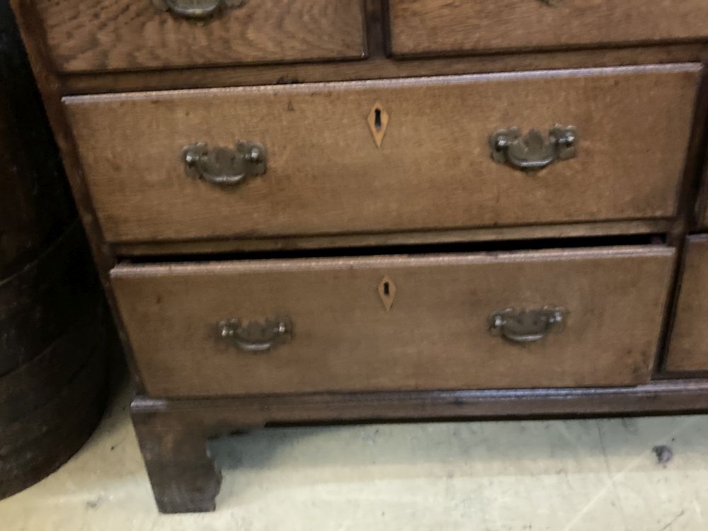 A George III oak housekeepers cupboard, width 138cm depth 52cm height 174cm
